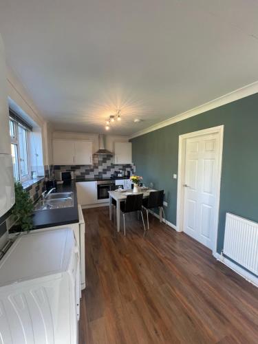 a large kitchen with a table and a dining room at House Nr Bailgate Area and Cathedral Off road Parking and Garden in Lincoln