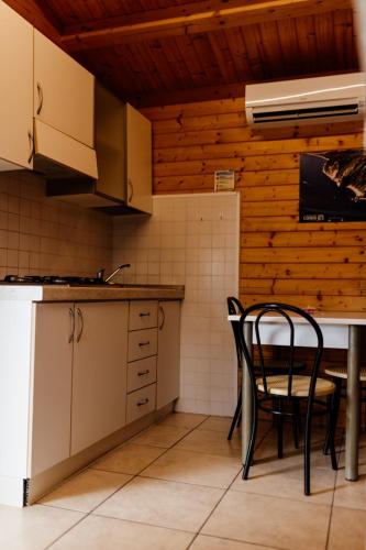 a kitchen with two chairs and a table in it at Camping La Pineta in Porto Recanati