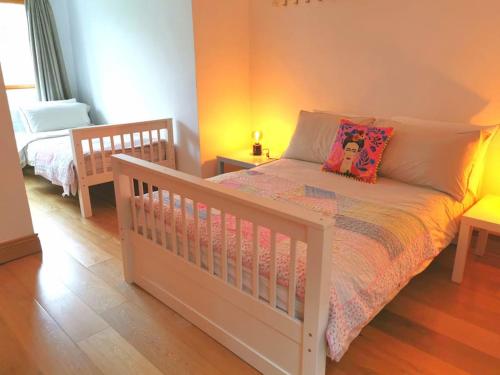 a bedroom with a white crib with a teddy bear on it at The Moorings- near the sea in Tramore
