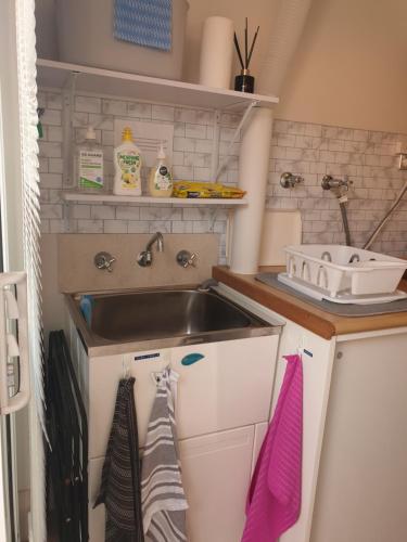 a kitchen with a sink and a counter with towels at Telperio - Guest suite max 4 Guests in Bunbury