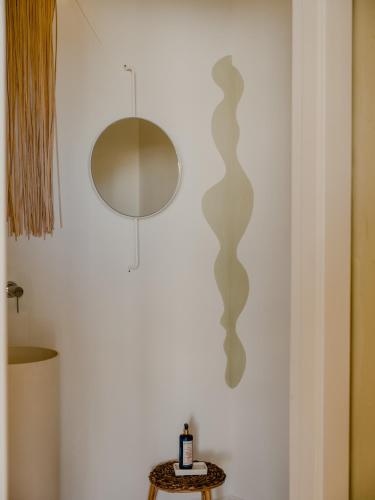 a mirror on a wall next to a table at Amagatay Luxury Boutique Hotel - Adults Only in Alaior