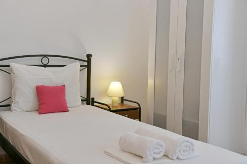 a bedroom with a bed with towels on it at Maria's House in Hydra