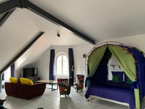 a bedroom with a bed and a couch in a room at L’INSOLITE in Pierry