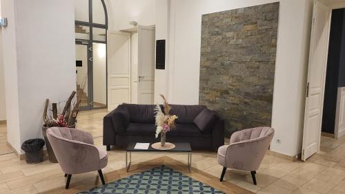 a living room with a couch and two chairs at D50 Hotel in Budapest