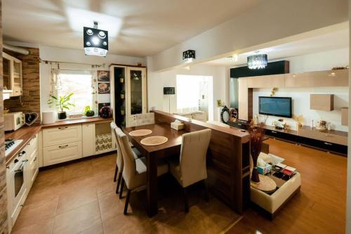 une cuisine avec une table en bois et une salle à manger dans l'établissement Apartament Lux Crialy - self check-in, à Timişoara
