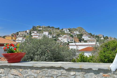 a view of a town from a wall with flowers at Maria's House in Hydra