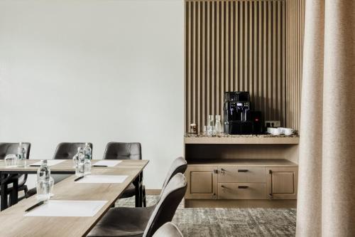 a row of tables and chairs in a restaurant at CALVARY Hotel & Restaurant Vilnius in Vilnius