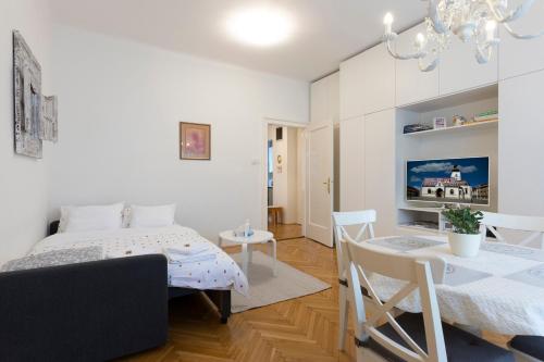 a bedroom with a bed and a dining room at Vedrana-Free garage in Zagreb