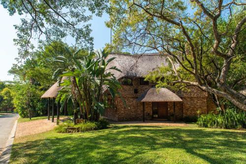 an old brick building with a grass roof at Kruger Park Lodge Unit No. 265 in Hazyview