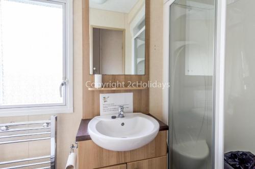 a bathroom with a sink and a shower at Beautiful 8 Berth Caravan At Cherry Tree Holiday Park In Norfolk Ref 70803c in Great Yarmouth
