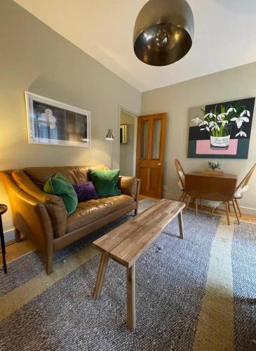 a living room with a couch and a coffee table at Beautiful & Cosy 2BD House - Southwark in London