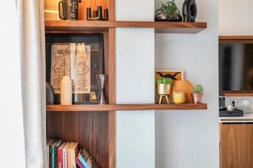 a room with wooden shelves with books at CARD Hôtel in Paris