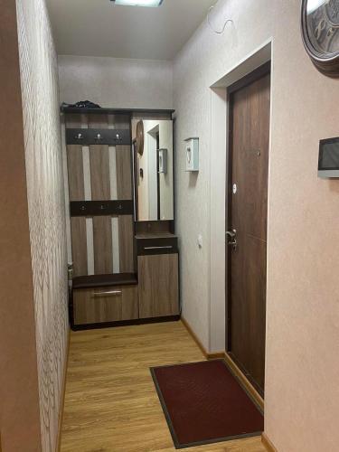 a hallway with a door to a room with wooden floors at APARTMENT PREMIUM VIP in Berdychiv