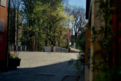 an empty parking lot with trees and a fence at Residenza dei Molini Monza centro in Monza