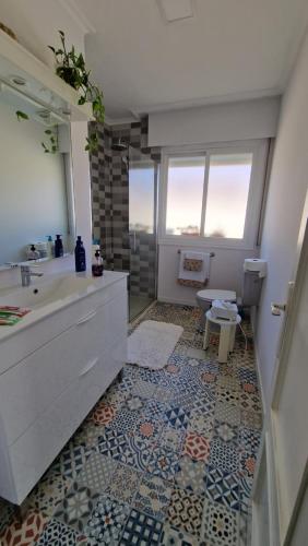 a bathroom with a tub and a sink and a mirror at Corazón do Val da Louriña-Área Vigo in Pontevedra