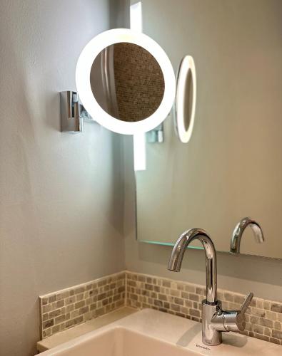 a bathroom with a sink and a mirror at The Bar Convent Guest House in York