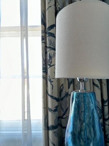 a blue glass lamp sitting next to a window at The Bar Convent Guest House in York