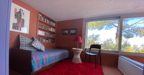 a bedroom with a bed and a large window at Villa with swimming pool and tennis/basketball court in Theológos