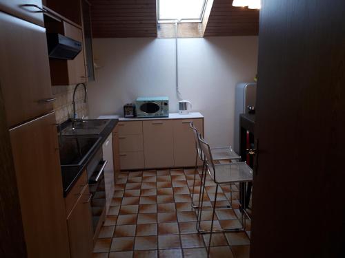 a small kitchen with a sink and a chair in it at Karl-Stieler-Straße in Bruckmühl