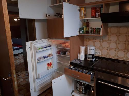 a refrigerator with its door open in a kitchen at Karl-Stieler-Straße in Bruckmühl