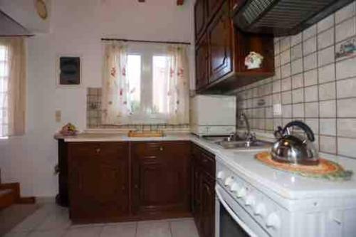 a kitchen with a sink and a counter top at “ Nicolas traditional house” in Gardeládes
