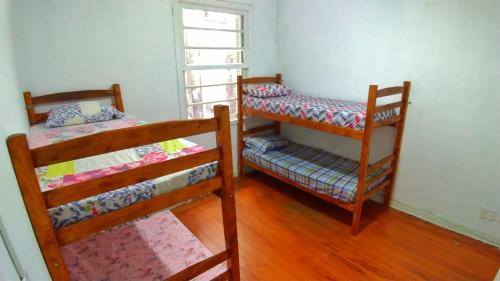 a bedroom with two bunk beds and a window at Varandas da Paulista in Sao Paulo