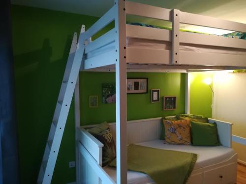 a bunk bed in a room with green walls at WohlFühlPlatz´l in Stegersbach