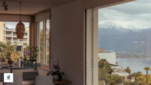 a room with a window with a view of a mountain at Casa Teatro Panoramico 5 Star Holiday House in Locarno