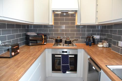 a kitchen with a counter with two pots on the stove at Mayflower Boutique Apartment - 2 Bedrooms Apartment - Stayseekers in Salisbury