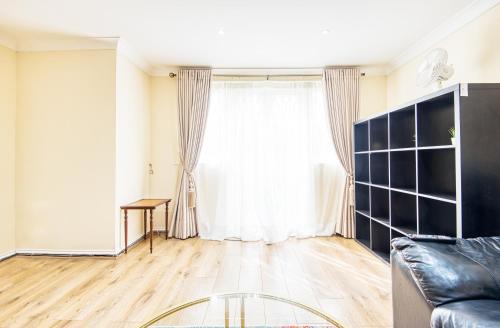 a living room with a couch and a window at Austin David Apartments - Hendon Pad in Hendon