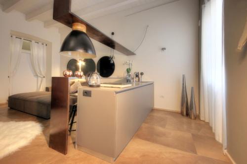 a kitchen with a sink and a refrigerator in a room at Urban Central Suites in Cagliari