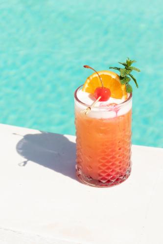 a drink sitting on a table next to the water at Cavo Bianco Boutique Hotel & Spa in Kamari