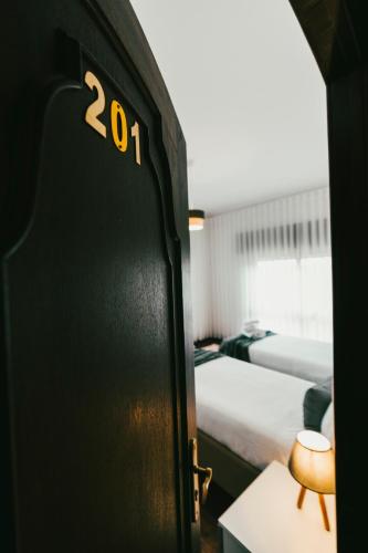 a door in a room with two beds at Quinta da Costinha in Alijó