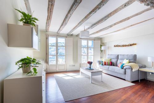 a living room with a couch and a table at IZARO Best View in Bermeo