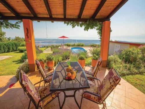 a table and chairs on a patio with a view at Villa Mery in Šmrika