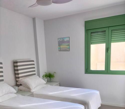 um quarto com 2 camas e uma janela verde em Sea View - Ultra Modern - Roof Terrace- Front Line em Mojácar