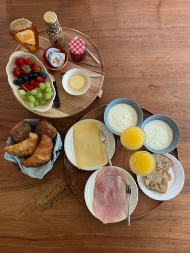 a table with plates of food and eggs and bread at Bed & breakfast De Loeghoeve in Anderen