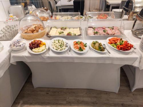 a buffet table with many plates of food on it at Karat in Warsaw
