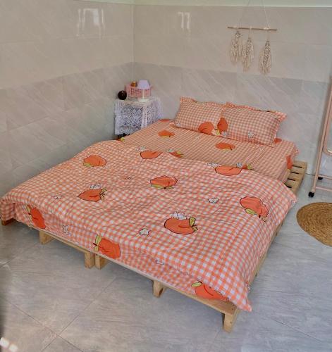 two twin beds in a bedroom with a bedspread with cows on it at Homestay Tuyết Trinh in Nha Trang