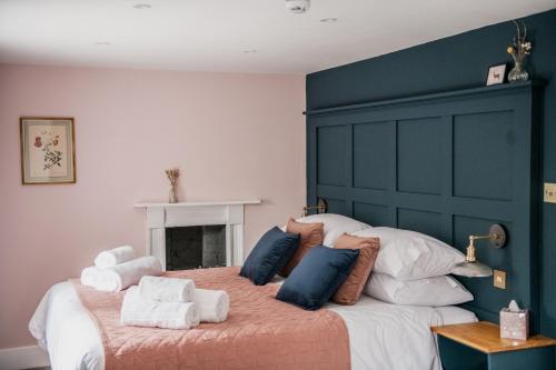 a bedroom with a large bed with towels on it at The Heathcock Boutique Hotel - Room 1 in Cardiff