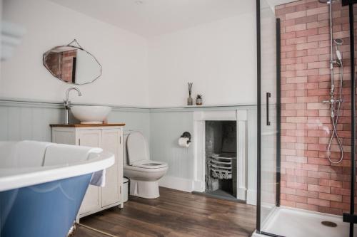 a bathroom with a toilet and a sink and a shower at The Heathcock Boutique Hotel in Cardiff