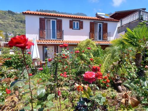 a house with flowers in front of it at Tropical Garden in Arco da Calheta