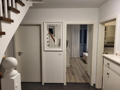 a hallway with a white door and a staircase at Haus für vier, kinderfreundlich! in Steinhagen