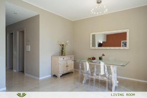 a dining room with a glass table and a dresser at Dependence del Parco in Porlezza