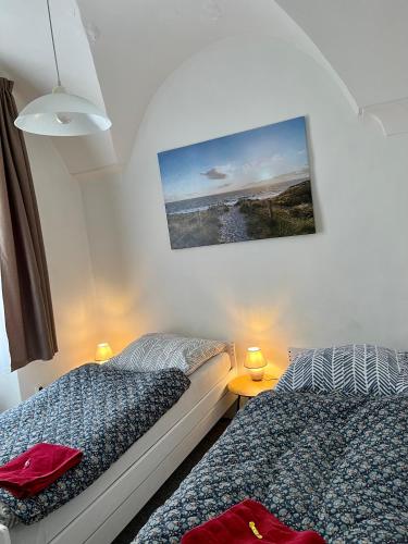a bedroom with two beds and a picture on the wall at GRAN hostel in Banská Bystrica