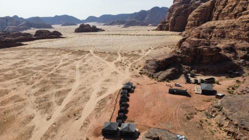 an aerial view of a desert with rocks and mountains at Beduin Star Trail Camp in Wadi Rum