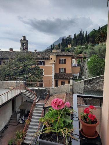 a view from the balcony of a building with flowers at Il limone in Gargnano