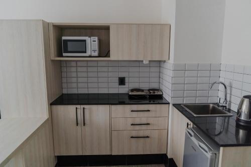 Kuchyň nebo kuchyňský kout v ubytování Quijano Hotel - Aparts & Suites