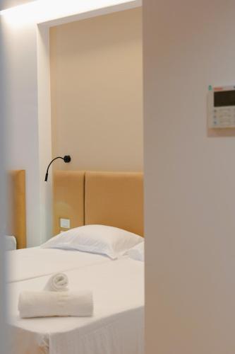 a bedroom with a bed with a towel on it at Hotel ABA in Ksamil