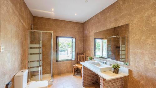 a bathroom with a sink and a mirror at Santa Marta Archidona by Ruralidays in Archidona